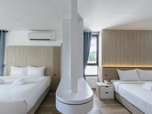a hotel room with two beds and a heater at B2 Krabi Premier Hotel in Ao Nang Beach