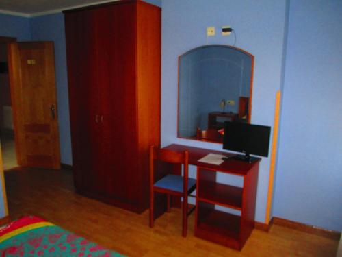a room with a desk with a computer and a mirror at Hotel Brisas del Sella in Ribadesella