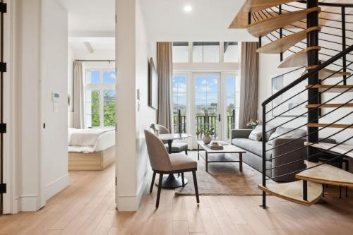 a living room with a spiral staircase and a bedroom at Casa Riviera - Boutique Apartments in Downtown Santa Barbara in Santa Barbara
