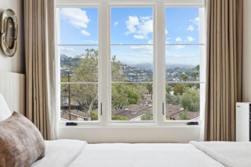 a bedroom with a large window with a view at Casa Riviera - Boutique Apartments in Downtown Santa Barbara in Santa Barbara