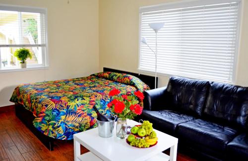 a living room with a couch and a bed at Ocean Drive Villas in Hollywood