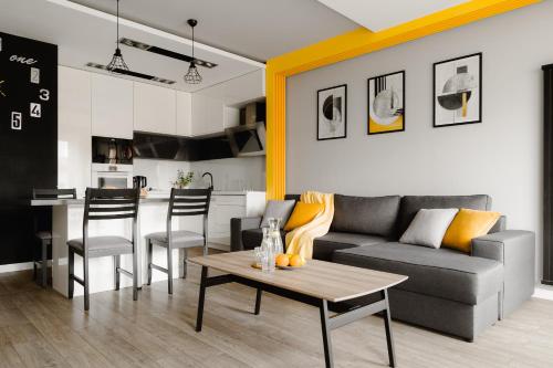 a living room with a couch and a table at Prestige Apartaments 79 in Wrocław