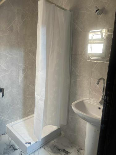 a bathroom with a shower and a sink at Porto marina Panoramica sea view in front marina 2 in El Alamein