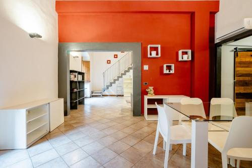 ein Esszimmer mit roten Wänden sowie einem Tisch und Stühlen in der Unterkunft Tower inn in Florenz