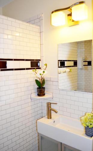 a white bathroom with a sink and a mirror at Ocean Drive Villas in Hollywood