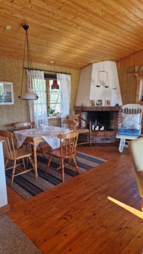 a dining room with a table and chairs and a fireplace at Säbytorp in Kil