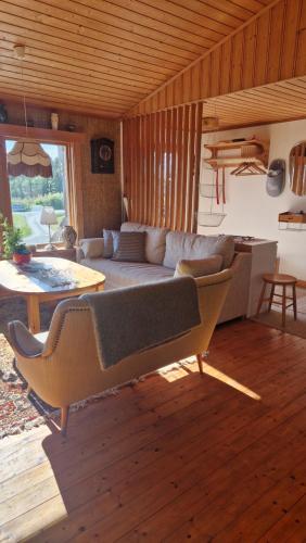 a living room with a couch and a table at Säbytorp in Kil