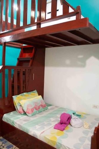 a bunk bed with two towels on the bottom bunk at Casa De Moore - Ocean & Garden View Siargao in General Luna