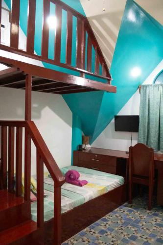 a bedroom with a bunk bed and a staircase at Casa De Moore - Ocean & Garden View Siargao in General Luna