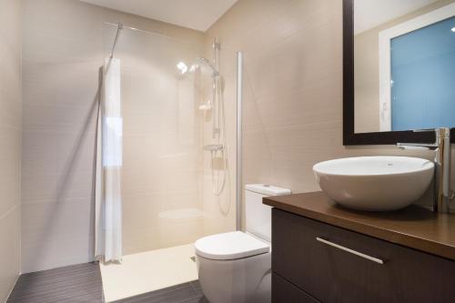 a bathroom with a toilet and a sink and a shower at San Roque Center - IB. Apartments in San Sebastián