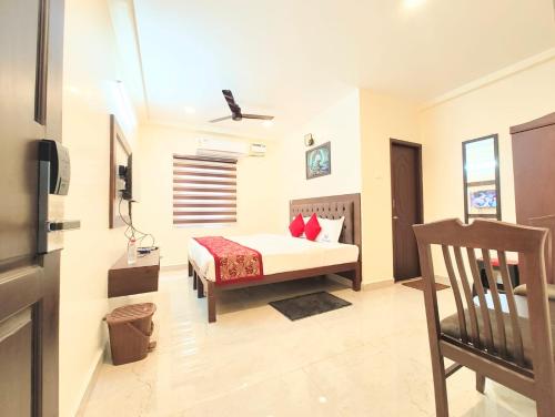 a bedroom with a bed and a chair in a room at MG Park in Chennai