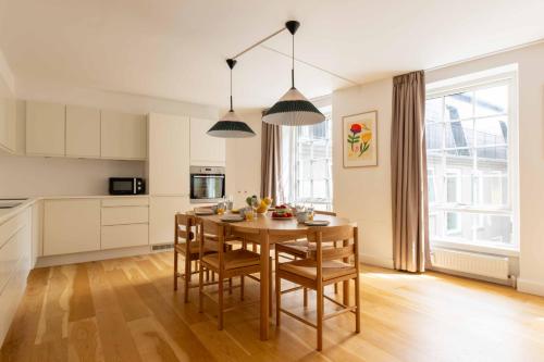a kitchen and dining room with a table and chairs at Family-Friendly Home for 10 in Prime Location in Copenhagen