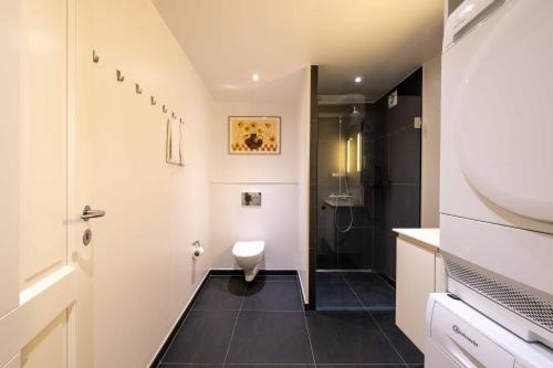 a small bathroom with a toilet and a shower at Family-Friendly Home for 10 in Prime Location in Copenhagen