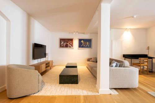 a living room with a couch and a table at Family-Friendly Home for 10 in Prime Location in Copenhagen