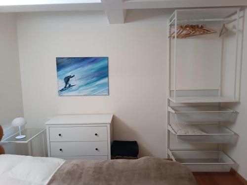 a bedroom with a bed and a dresser and a closet at Appartamenti Vacanze Casa -Residence Albare - check in Vacanze Casa - Marilleva 900 in Marilleva
