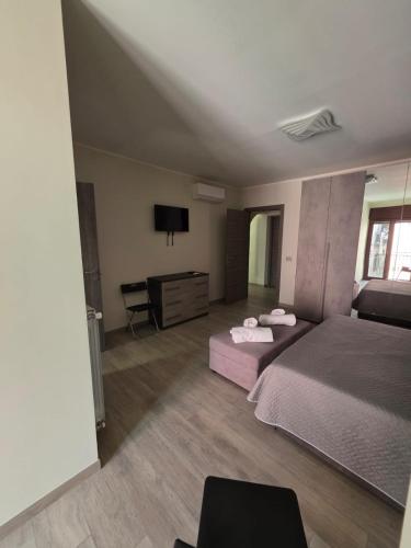 a large bedroom with two beds and a desk at Casa Vacanza da Patty in San Rufo