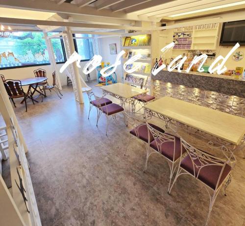 a restaurant with tables and chairs in a room at 玫瑰花園民宿親子寵物友善 in Hualien City