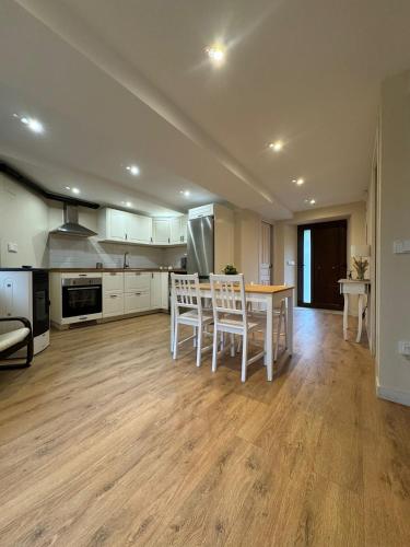 a kitchen with a table and chairs in a room at La casa de cuatro caminos in Arenas de Cabrales