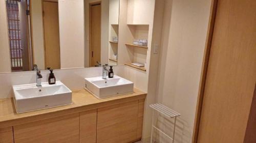a bathroom with two sinks and a large mirror at Centrale Hotel Kyotango in Kyotango