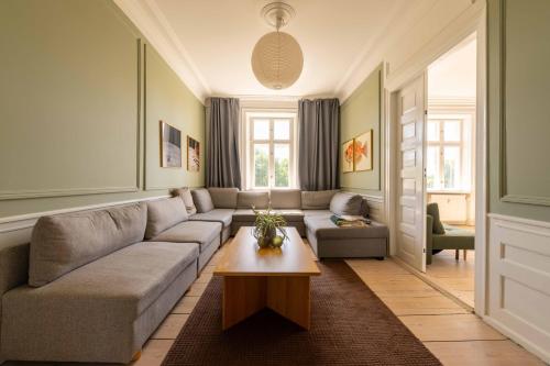 a living room with a couch and a table at Lovely Apartment Overlooking King's Garden in Copenhagen