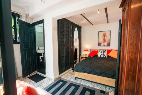 a bedroom with black doors and a bed at Dar Rania in Tangier