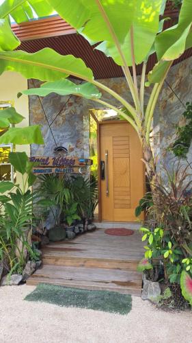 a wooden walkway leading to a house with a yellow door at ROYAL Village Dhangethi Maldives in Male City
