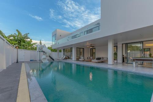 a swimming pool in the backyard of a house at TML-6 bedrooms-independent swimming pool and Luxury KTV room and fitness area and pool table in Ban Huai Yai
