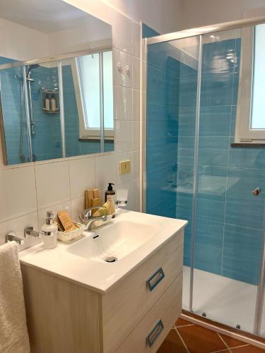 a bathroom with a sink and a shower at La Perla House in Anacapri