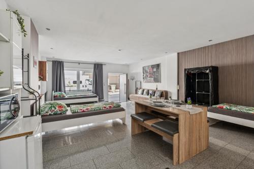 a living room with two beds and a table at Monteur Wohnung Kleve KL01 - Innenstadt in Kleve