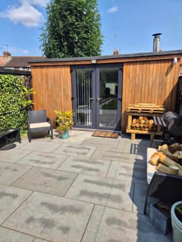 a patio with a building with sliding glass doors at West Lodge in Hatfield