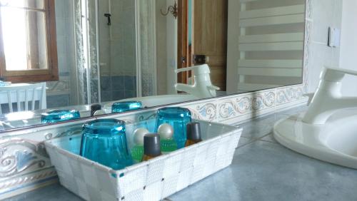 a bathroom with a sink and a mirror at Chateau la Bouriette in Moussoulens