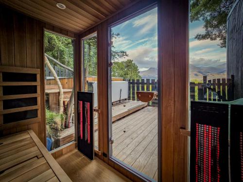 a screened in porch with a large glass door at Kinloch Wilderness Retreat in Glenorchy