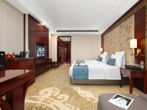 a hotel room with a bed and a television at Days Hotel & Suites China Town---Five minutes to reach Changsha Station, the metro Line 2 & Line 6 are nearby,free gym & laundromat,Chinese and Western buffet breakfast is offered on the 31st floor in Changsha