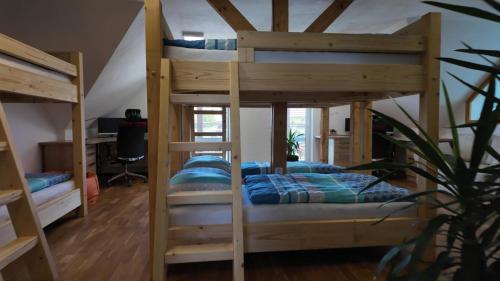 a bedroom with two bunk beds and a desk at Rekreační dům Štěpánka in Česká Kubice