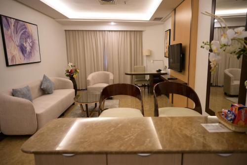 a living room with a couch and a table at Best Western Plus Mahboula in Kuwait