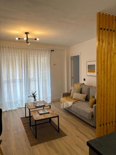 a living room with a couch and a table at VictrixHomes in León