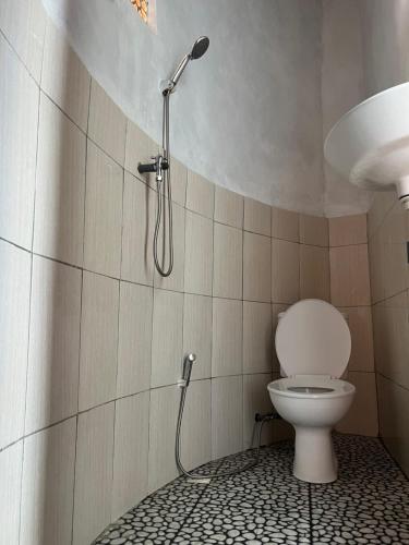 a shower in a bathroom with a toilet at Tera glamping bali 2 in Baturaja