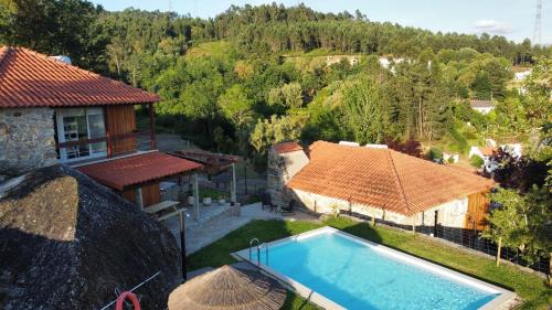 an aerial view of a house with a swimming pool at Quinta Encosta do Penedo - Wellness Retreat - Gerês in São Jorge