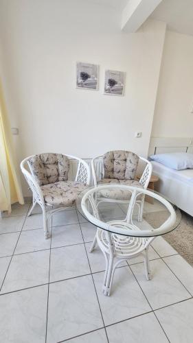 two chairs and a coffee table in a room at Apartmány a penzion Hacienda in Domanín