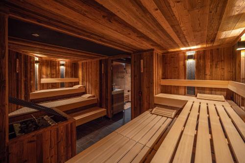 an empty sauna with wooden walls and wooden floors at Wohlfühlhotel Berwanger Hof in Obermaiselstein