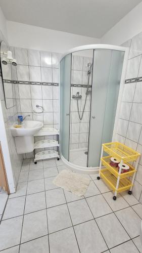 a bathroom with a shower and a sink at Apartmány a penzion Hacienda in Domanín