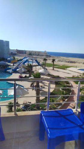 a view of a resort with palm trees and a pool at قريه سورتلاج مرسي مطرح الفيو المميز in Marsa Matruh
