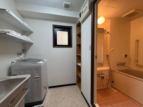 a bathroom with a sink and a washing machine at 朝日街の宿 An inn on Asahi Street in Tokyo