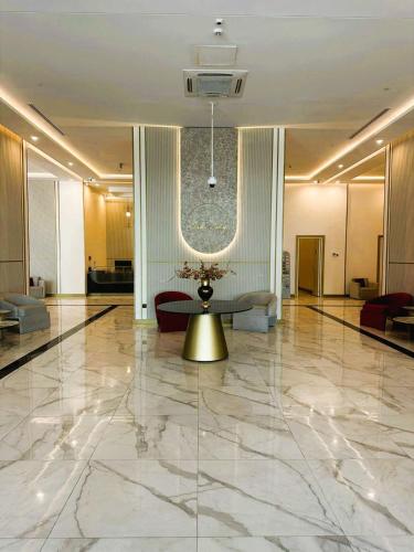 a lobby with a table in the middle of a building at Orbi City Hotel Official D Block in Batumi