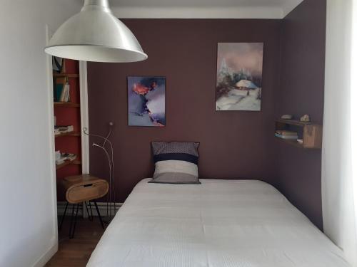 a bedroom with a bed with a white mattress at Chambres Zola in Nantes