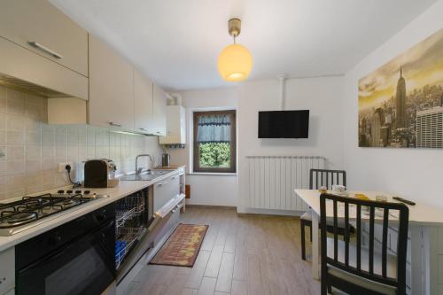 a kitchen with a sink and a stove top oven at Welcome Home 1 Meana di Susa in Meana di Susa