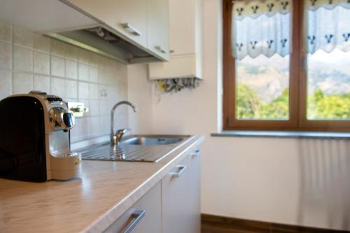 a kitchen with a toaster sitting on a counter at Welcome Home 2 Meana di Susa in Meana di Susa