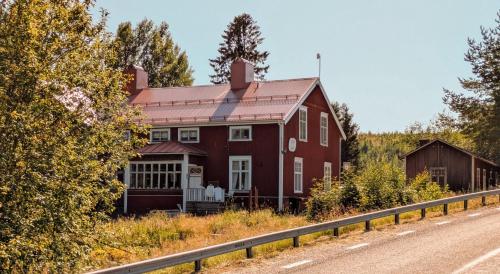 a large red house on the side of a road at Bright and spacious living in historic building in Eriksfors