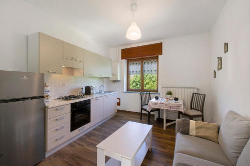 a kitchen and living room with a couch and a table at Welcome Home 2 Meana di Susa in Meana di Susa