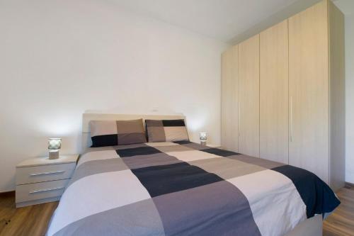 a bedroom with a large bed and a cabinet at Welcome Home 2 Meana di Susa in Meana di Susa
